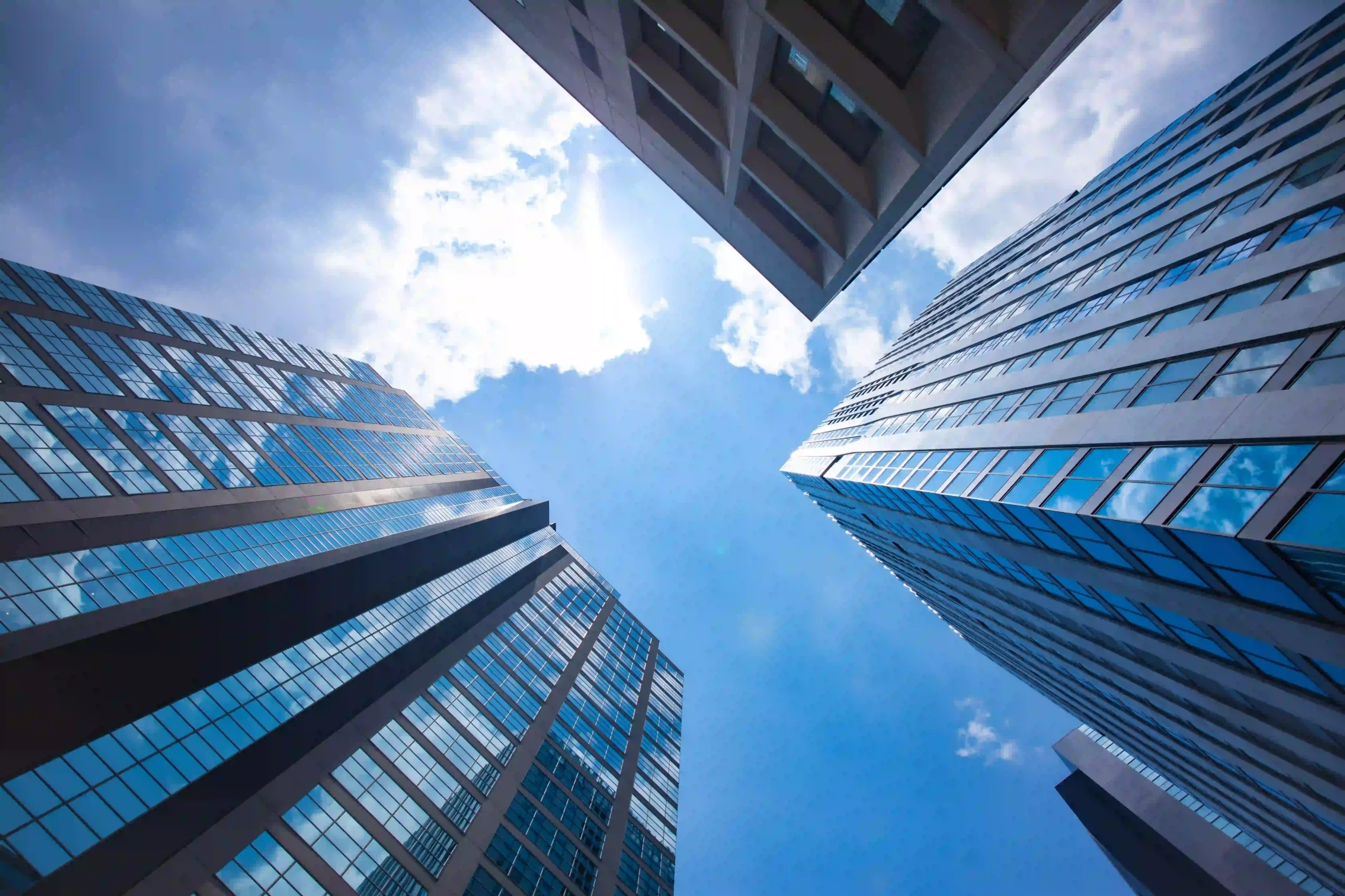Modern skyscrapers looking up at blue sky architecture